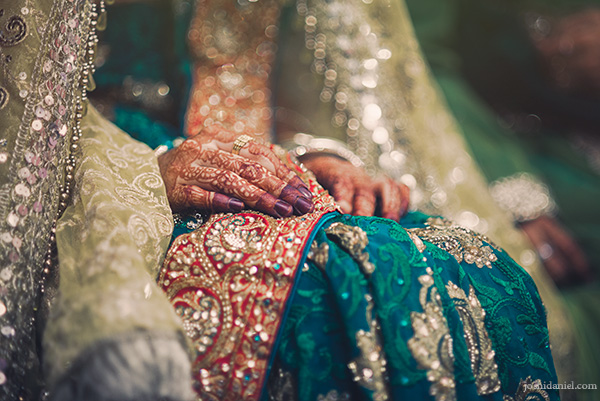 A bride’s mehndi painted hands on her wedding day